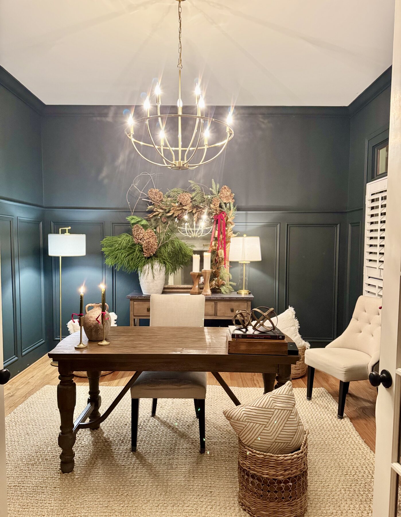 Home office with a dramatic chandelier and traditional furnishings