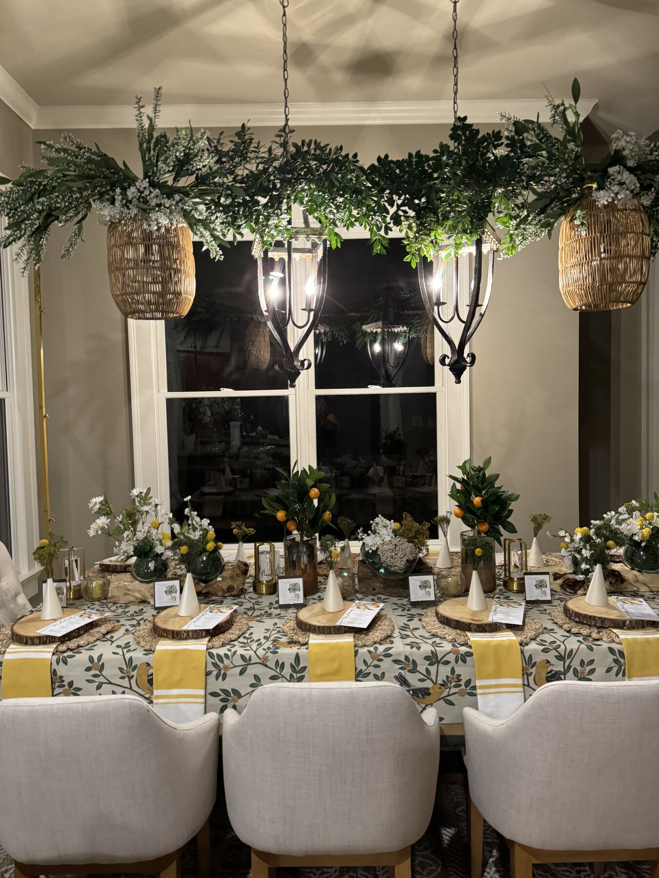 Holiday dining room layered with greenery and warm light