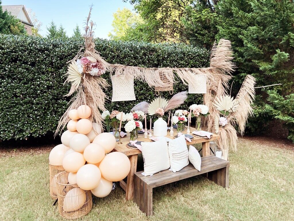 Outdoor gathering vignette with pampas grass and neutral florals